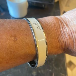 Hermes bangle bracelet cream color trimmed in silver.